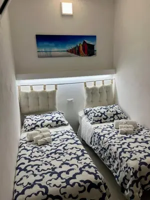 two beds sitting next to each other in a room at Casa Vacanza Mare in Castellammare del Golfo