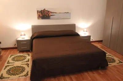 a bedroom with a bed with two night stands and two lamps at La Casetta in Palermo