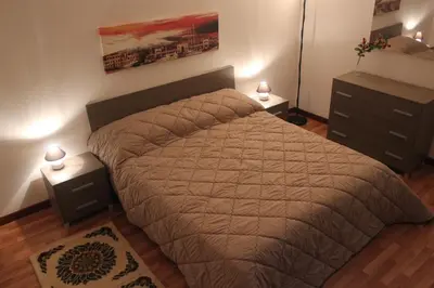 a bedroom with a large bed and two night stands at La Casetta in Palermo