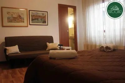 a bedroom with a bed and a couch in it at La Casetta in Palermo