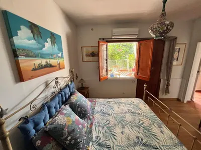 a bedroom with a bed and a window at Casa Perciata - Locazione Turistica in Mondello
