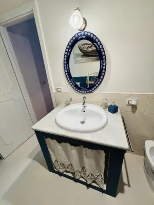 a bathroom with a sink and a mirror at Casa Perciata - Locazione Turistica in Mondello