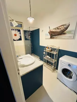 a bathroom with a sink and a washing machine at Casa Perciata - Locazione Turistica in Mondello