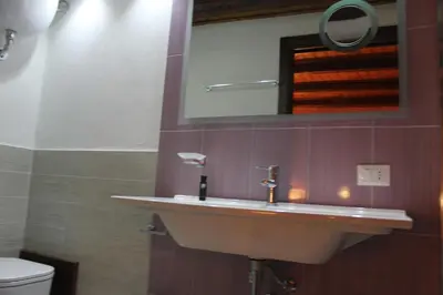 a bathroom with a sink and a mirror and a toilet at B&B Xenia in Palermo