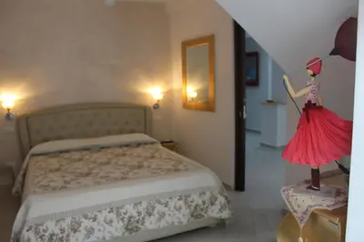 a bedroom with a bed and a dress on a dummy at B&B Xenia in Palermo