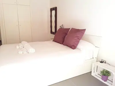 a bedroom with two beds with purple and white pillows at Cassari UpArtments in Palermo