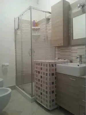 a bathroom with a shower and a toilet and a sink at Villa Iris in Castellammare del Golfo