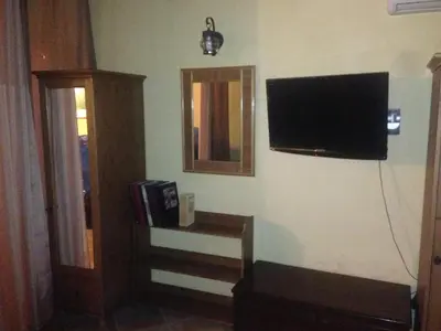 a living room with a flat screen tv on the wall at Junior Suite Cattedrale in Palermo