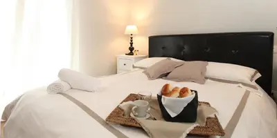a bedroom with a bed and a couch and a table at Baglio San Giovanni in Palermo