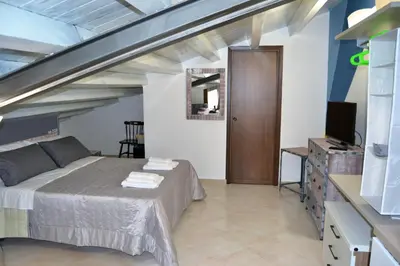 a bedroom with a bed and a tv in a room at Appartamento Delle Pergole in Palermo