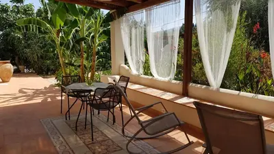 a balcony with a table and chairs on it at Terre e Torri Country Resort in Lascari