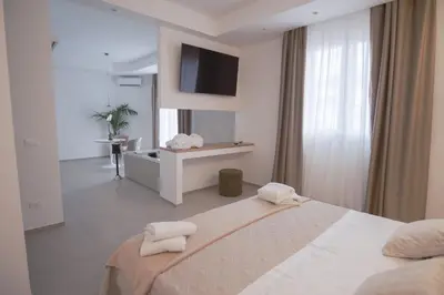 a white bedroom with a bed with towels on it at Le Muse Mondello in Mondello