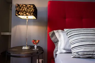 a lamp on a table next to a bed at Le Muse Mondello in Mondello