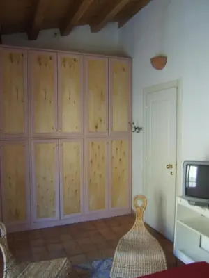 a living room with a large cabinet and a tv at Olivella Suite Ecological House in Palermo