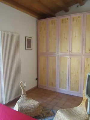a bedroom with a large wooden cabinet in a room at Olivella Suite Ecological House in Palermo