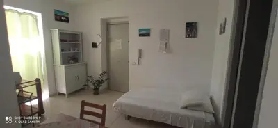 a bedroom with a bed and a table and chairs at Casa Il Papiro TRS-IT-SIC-20280 in Palermo