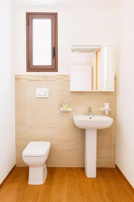 a bathroom with a toilet and a sink and a mirror at Il Glicine Appartamenti & Rooms in Castellammare del Golfo