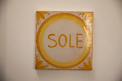 a sale sign on a wall with a mirror at Vespri Apartments in Palermo