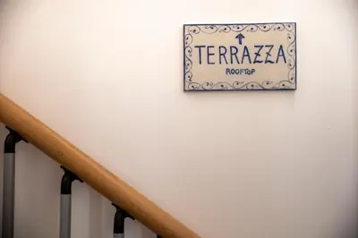 a sign on a wall next to a stairway at Vespri Apartments in Palermo