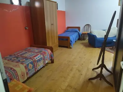 a room with two beds and a bedroom with a mirror at Segesta Antichi Sapori in Calatafimi