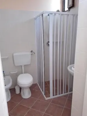 a bathroom with a shower with a toilet and a sink at Segesta Antichi Sapori in Calatafimi