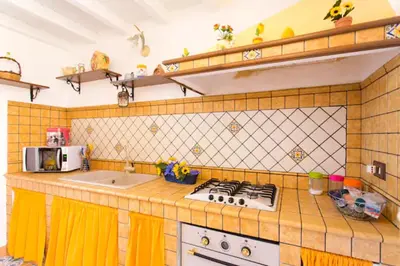 a kitchen with a sink and a stove top oven at Casa nobiliare in Palermo