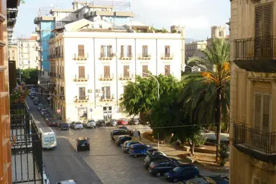 a city street with cars parked in front of a building at Casa nobiliare in Palermo