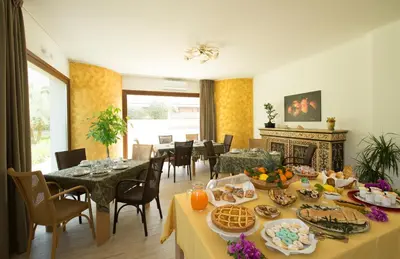 a dining room with a table with food on it at I Segreti di Antonina in Castelluzzo