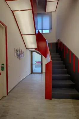 a staircase in an office building with red and black at Hospitality Hotel in Palermo