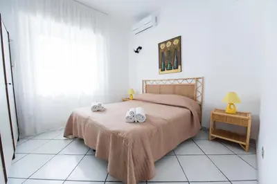 a bedroom with a bed with two towels on it at Villa Trinacria Apartments in Alcamo Marina