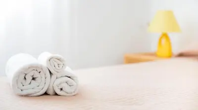 a pile of towels sitting on top of a bed at Villa Trinacria Apartments in Alcamo Marina