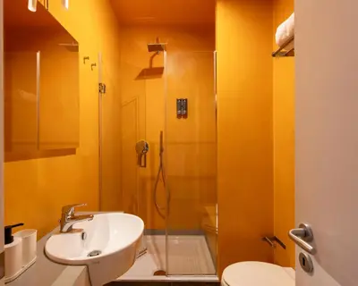 a bathroom with a sink and a shower at Pretoria Rooms in Palermo