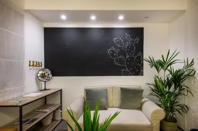 a living room with a couch and a blackboard on the wall at Pretoria Rooms in Palermo