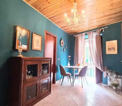 a dining room with a table and chairs and a chandelier at Casakameusa in Palermo