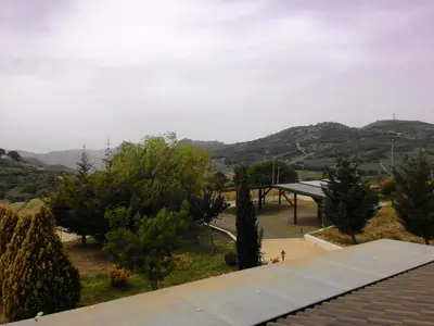 a view from the roof of a building with trees and mountains at Il Noce Antico in Bisacquino