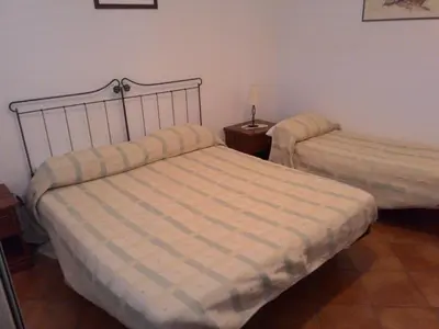 a bedroom with two beds and a lamp at Il Noce Antico in Bisacquino
