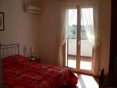 a bedroom with a bed and a large window at Il Noce Antico in Bisacquino