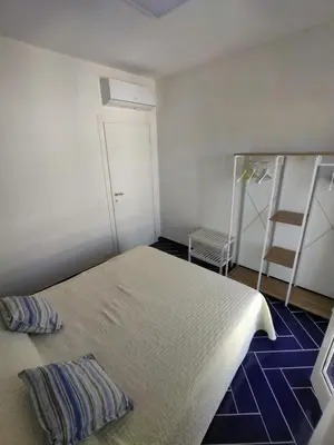 a small bedroom with a bed and a ladder at Casa Vacanze Playa 54 in Castellammare del Golfo