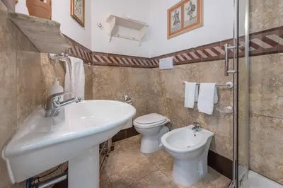 a bathroom with a sink and a toilet at Palazzo Benso in Palermo