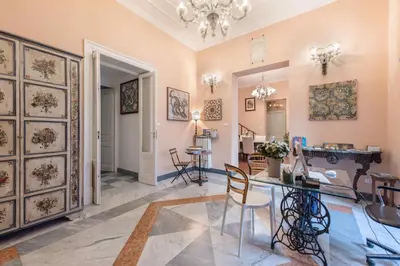 a living room with a table and chairs at Palazzo Benso in Palermo