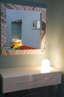 a mirror above a white dresser in a bedroom at Le Case Moncada in Palermo