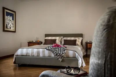 a bedroom with a bed with a blanket on it at Dimora Torremuzza in Palermo