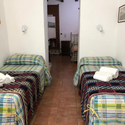 a room with three beds with towels on them at Bahalara Alloggio in Palermo