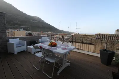 a table and chairs on a balcony with a view at Mare Sole Relax in Castellammare del Golfo