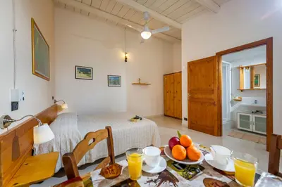 a living room with a table with fruit on it at Agriturismo Finazzo in Balata di Baida