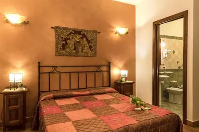 a bedroom with a bed and a bathroom at Alba Marina B&B in Castelluzzo