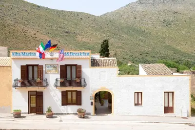 a building with a kite on top of it at Alba Marina B&B in Castelluzzo