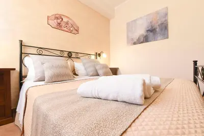 a bedroom with two beds with white pillows at Bed & Breakfast Goccia Marina in San Vito lo Capo