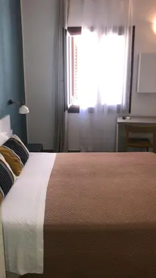 a bedroom with a large bed with a window at La Meridiana in Castellammare del Golfo