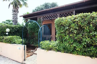 a gate in front of a house with bushes at Acquamarina32 in San Vito lo Capo